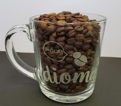 idioma roastery Clear, glass mug, logo on 2 sides with bean bird at bottom of mug.  Coffee sold separately.